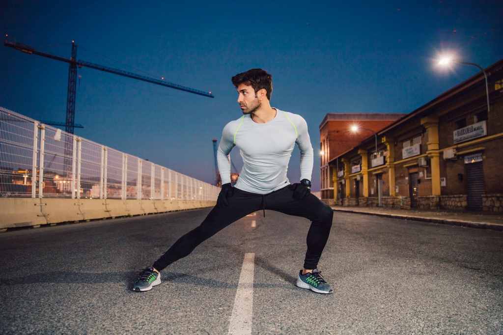 handsome man exercising on road